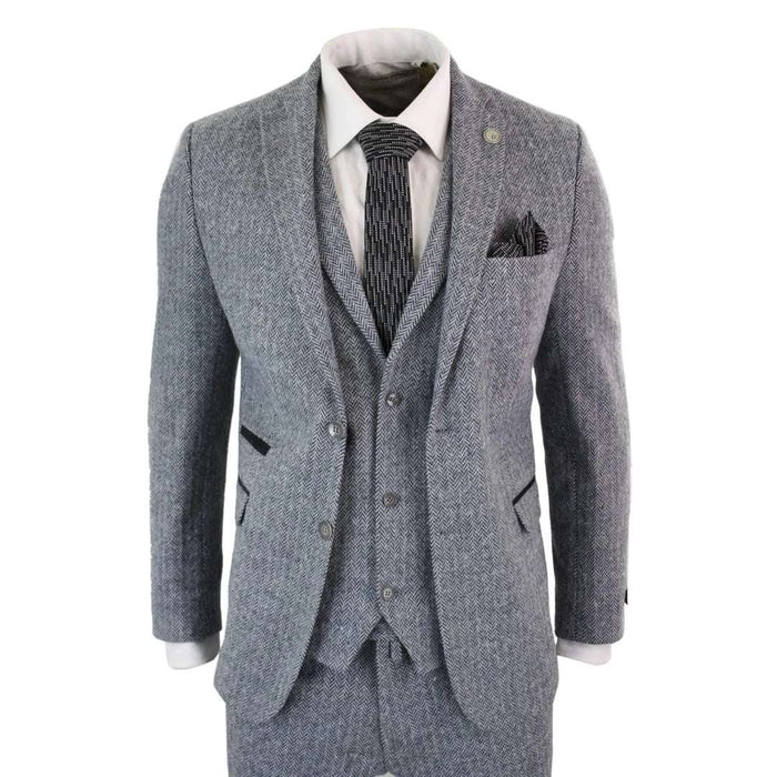 Men's light grey 3-piece tweed suit with herringbone wool fabric, tailored fit, includes blazer, waistcoat, and trousers, styled with white shirt and black patterned tie