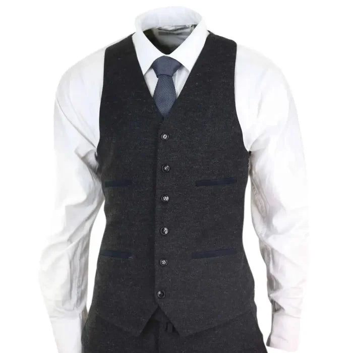 Men's dark gray wool tweed vest with five buttons, tailored fit, and subtle contrasting trim, worn over a white dress shirt with a navy tie