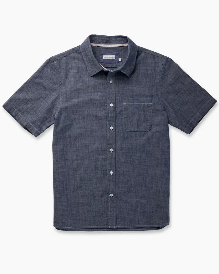 Ace Rivington Surplus Chambray short-sleeve button-up shirt in indigo rinse, flat lay on white background showing chest pocket and button placket