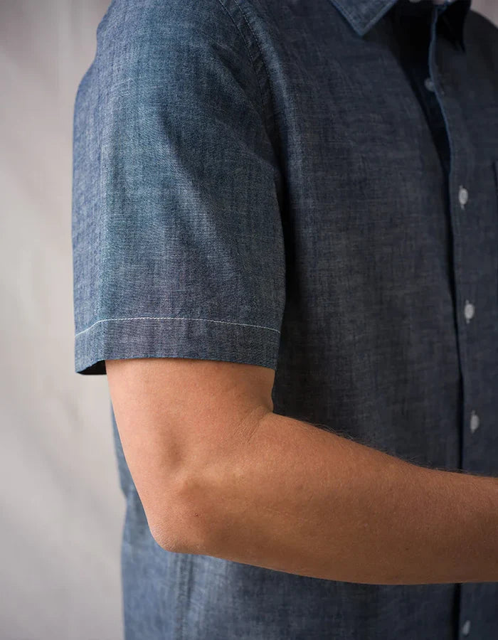 Detail shot of Ace Rivington Surplus Chambray shirt sleeve showing contrast stitching and indigo yarn-dyed chambray fabric