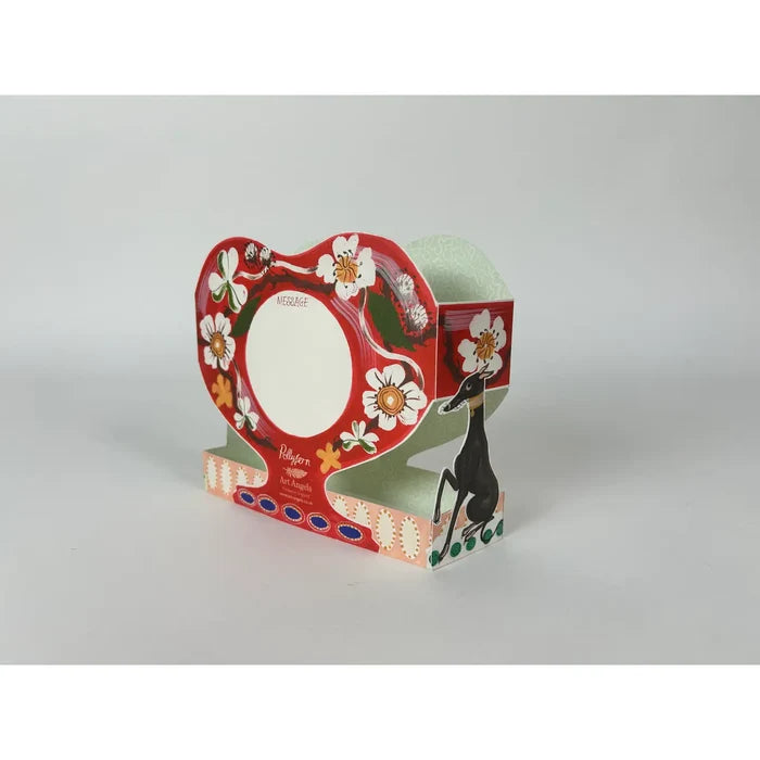 A pop-up card with floral design and a dog illustration on a gray background