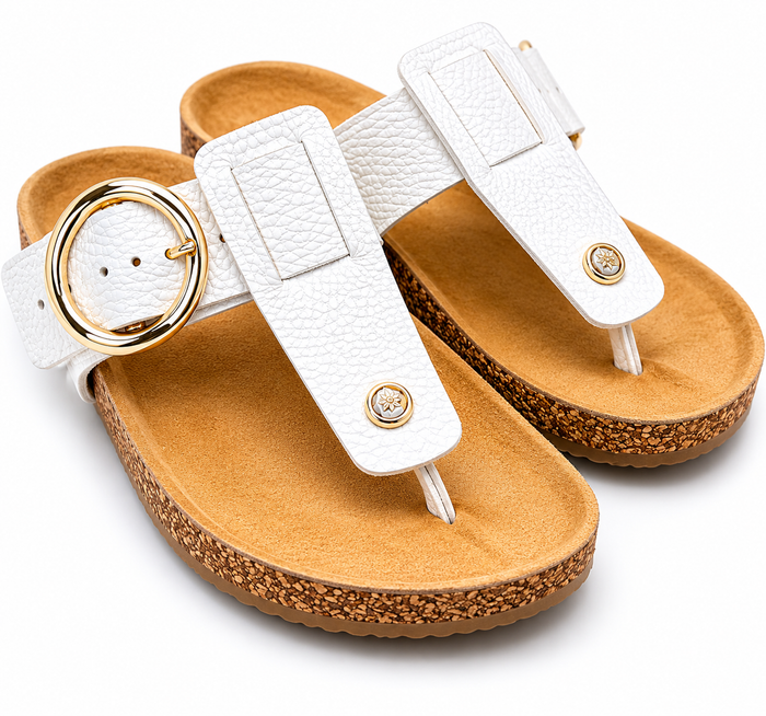 White sandals with gold accents on a white background