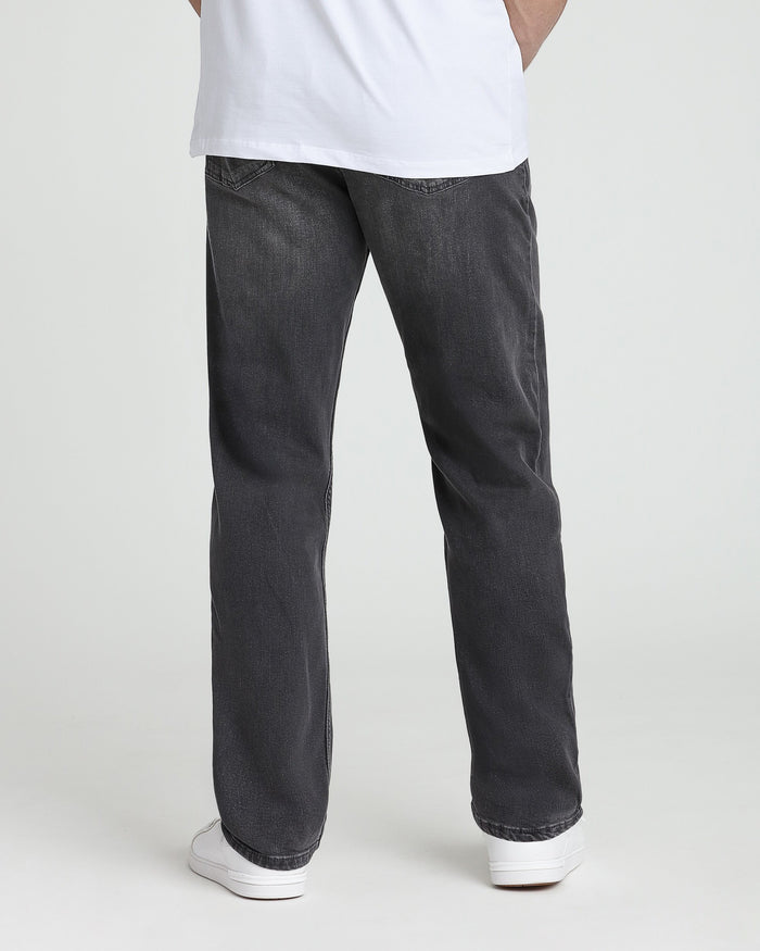 Charcoal grey denim jeans with relaxed fit, shown styled with white t-shirt and white sneakers.