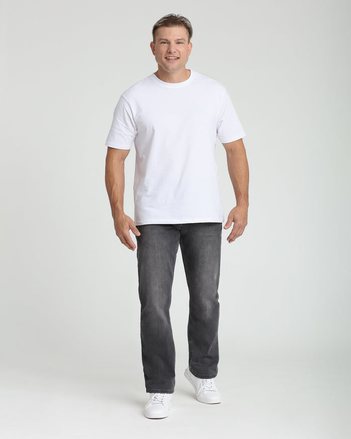 Man wearing white short-sleeve t-shirt and gray denim jeans with white sneakers.
