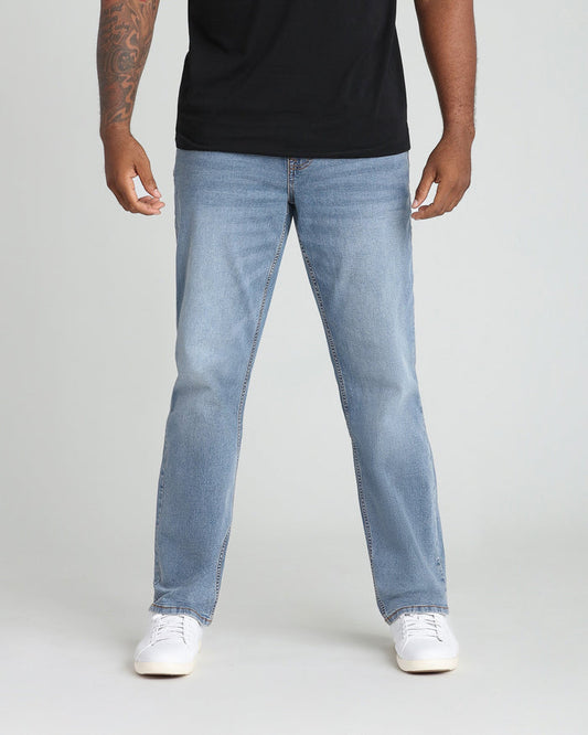 Light blue straight-fit jeans with visible stitching seams worn with black t-shirt and white canvas sneakers.