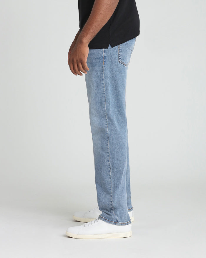 Light blue straight-leg jeans worn with a black shirt and white sneakers.